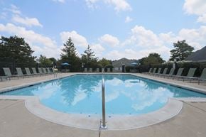 Centerville townhouse for rent - A large outdoor swimming pool with a blue sky and clouds reflected in the water.