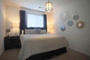 Centerville townhouse for rent - A bedroom with a bed, nightstand, and wall decorations.