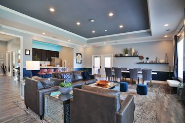 Mason apartment for rent - A modern living room with a grey sofa set and a glass coffee table.