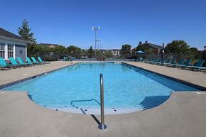 Mason apartment for rent - an empty pool with blue chairs around it
