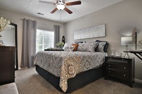 Loveland apartment for rent - a bedroom with a bed and a ceiling fan