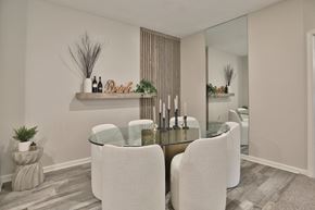 Fishers townhouse for rent - a dining room with white chairs and a glass table