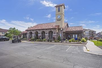 Moore apartment for rent - A parking lot in front of a building with a clock tower.