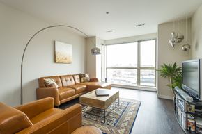 Allston apartment for rent - a living room with brown leather furniture and a television