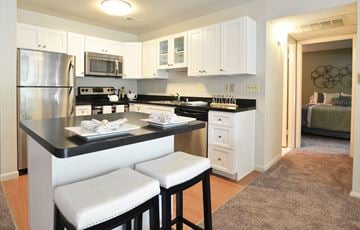 Cockeysville apartment for rent - A kitchen with white cabinets and a black countertop.