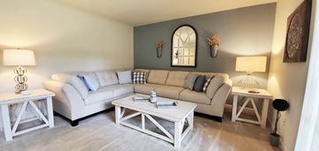 Cockeysville apartment for rent - A living room with a white couch and a coffee table.