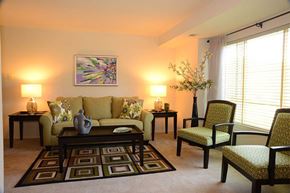 Essex apartment for rent - A living room with a green couch, two end tables, and a patterned rug.