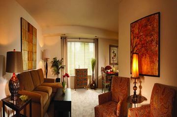 Essex apartment for rent - A living room with a couch, chairs, and a table with a vase on it.