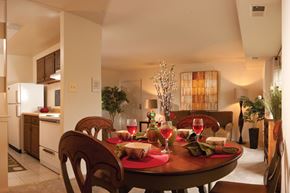 Essex apartment for rent - A dining room with a table set for two with wine glasses and plates.