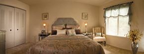 Essex apartment for rent - A bedroom with a bed, chair, and two lamps.