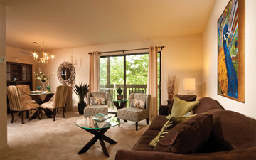 Essex apartment for rent - A living room with a glass coffee table and a large painting on the wall.
