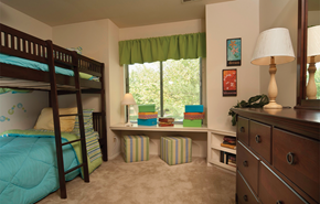Essex apartment for rent - A room with a bunk bed, a desk with a lamp, and a window with green curtains.