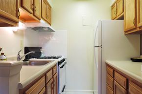 Parkville apartment for rent - A kitchen with wooden cabinets and a white refrigerator.