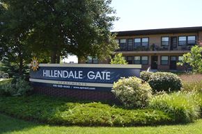 Parkville apartment for rent - A sign for Hillendale Gate Apartments is displayed in front of a building.
