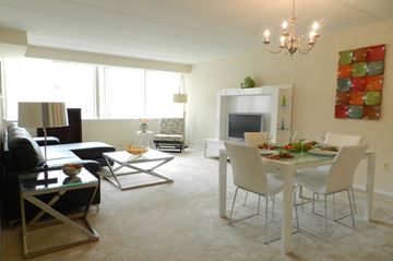 Parkville apartment for rent - A living room with a dining table set up with chairs.