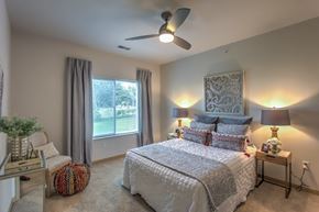 Cottage Grove apartment for rent - a bedroom with a bed and a ceiling fan