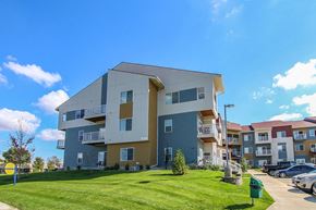 Cottage Grove apartment for rent - an apartment building with a green lawn in front of it