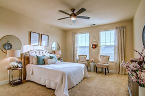 Madison apartment for rent - a bedroom with a large bed and a ceiling fan