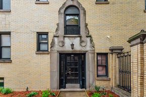 Chicago apartment for rent - a brick building with a black door and a window