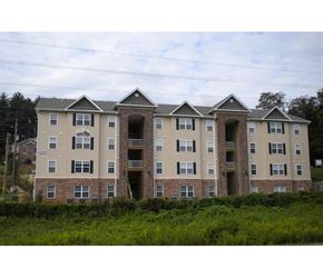 Cullowhee apartment for rent - an apartment building with three stories and a field