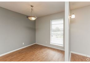 New Braunfels apartment for rent - an empty living room with a window and wood floors