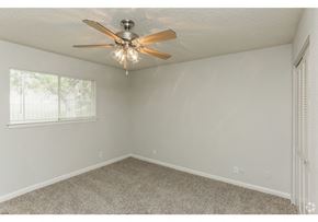 New Braunfels apartment for rent - a bedroom with a ceiling fan and a window