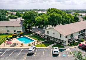 New Braunfels apartment for rent - an aerial view of a house with a swimming pool and a parking lot
