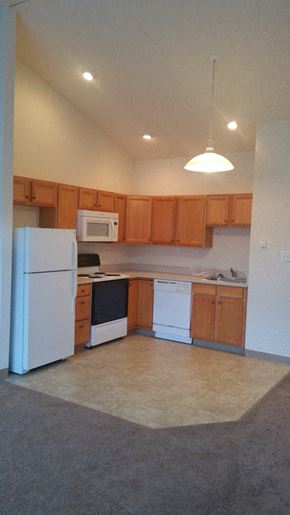 Nanticoke apartment for rent - A kitchen with white appliances and wooden cabinets.