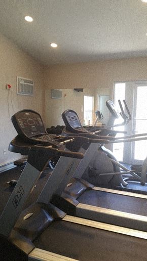 Nanticoke apartment for rent - A treadmill and a stationary bike are in a home gym.