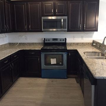 Nanticoke apartment for rent - A kitchen with a black oven and microwave.