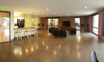 Richmond apartment for rent - an empty living room with a table and chairs and a kitchen