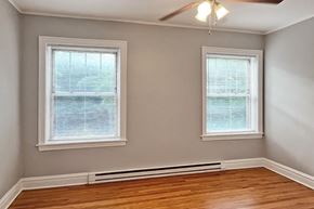 Oak Park apartment for rent - A room with two windows and a ceiling fan.