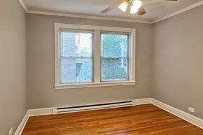 Oak Park apartment for rent - A room with a window and a ceiling fan.