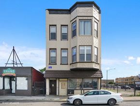 Chicago apartment for rent - a white car parked in front of a tall building