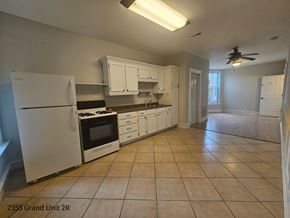 Chicago apartment for rent - an empty kitchen with white cabinets and a white refrigerator