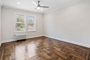 Montclair apartment for rent - an empty living room with wood floors and a ceiling fan