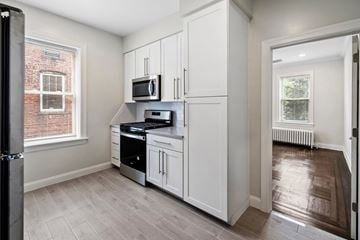 Montclair apartment for rent - a kitchen with white cabinets and a microwave
