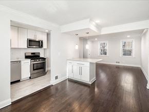 Upper Montclair townhouse for rent - A modern kitchen with white cabinets and stainless steel appliances.