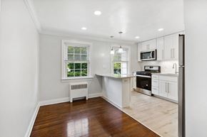 Springfield apartment for rent - an empty kitchen with white cabinets and a window