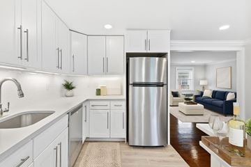 Springfield apartment for rent - A modern kitchen with a stainless steel refrigerator and white cabinets.