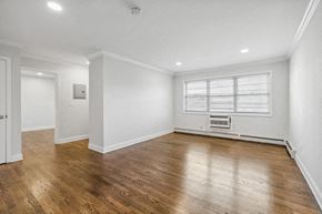 Orange apartment for rent - an empty living room with white walls and wood floors
