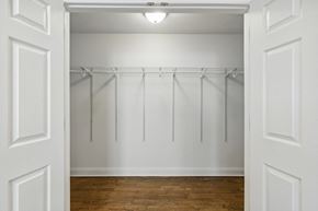 Orange apartment for rent - an empty room with white walls and a wood floor