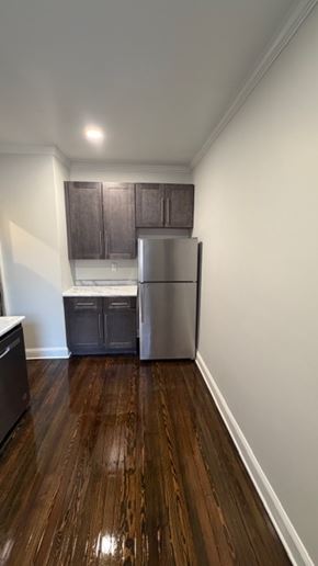 Jersey City apartment for rent - A kitchen with a refrigerator and cabinets.