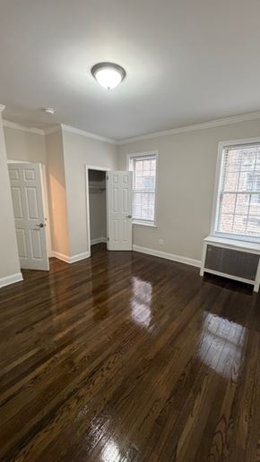 Jersey City apartment for rent - A room with wooden floors and a window.