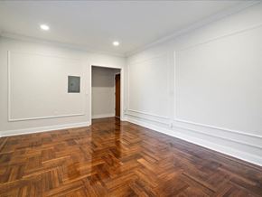 Jersey City apartment for rent - an empty living room with wood flooring and white walls