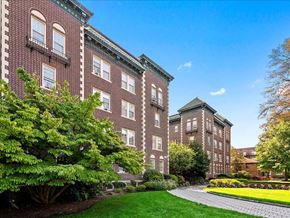 Summit apartment for rent - the front of a brick building with a garden and a pathway