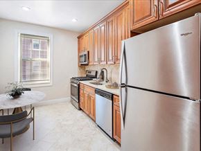 Summit apartment for rent - a kitchen with stainless steel appliances and wooden cabinets