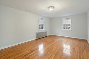 Bloomfield apartment for rent - an empty living room with a hardwood floor and a window