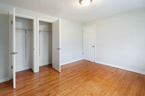 Bloomfield apartment for rent - an empty bedroom with wood floors and closet doors