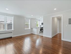 Upper Montclair apartment for rent - A spacious room with wooden floors and white walls.